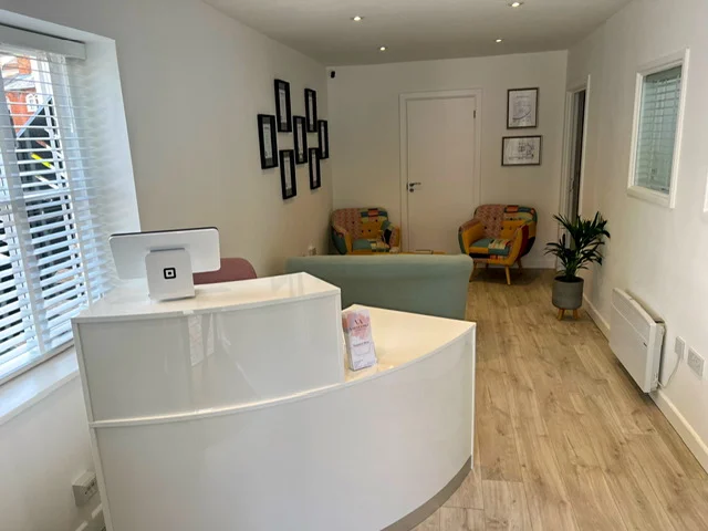 The reception and waiting area, with the desk and two armchairs.